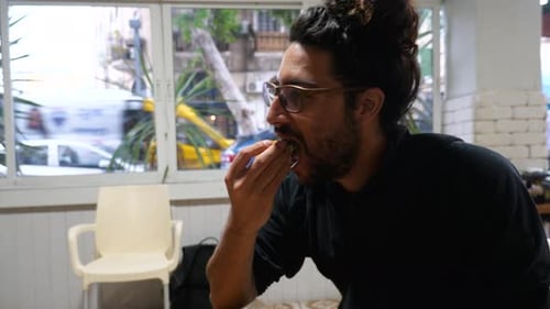 Arabian male enjoying company while enjoying delicious food.