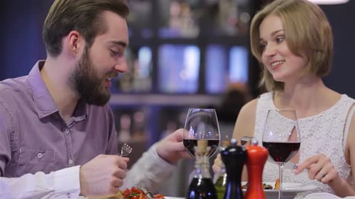 Charming Couple Enjoying a Romantic Dinner at an Elegant Restaurant