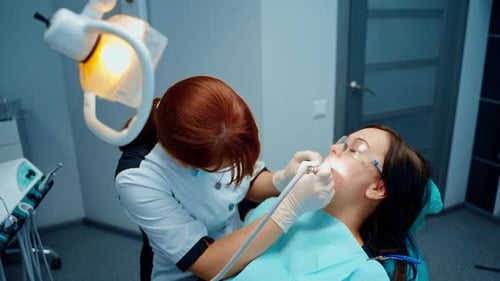 Doctor Examines Patient's Teeth in Dental Office