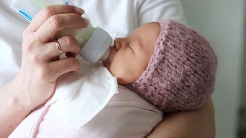 Newborn Baby Drinking Milk from Bottle