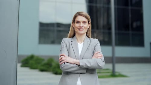 Confident Blond Woman Smiles in Business Attire