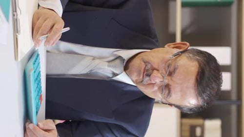 Adult man working with calculator in business setting