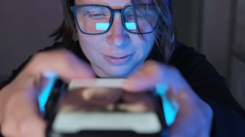 Person Using Smartphone at Night Close Up