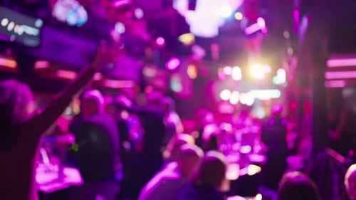 People Move Along Illuminated City Passageways Vivid Scene of Busy Night City with Reflections and