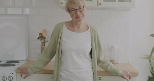 Smiling Senior Woman in a Bright Kitchen
