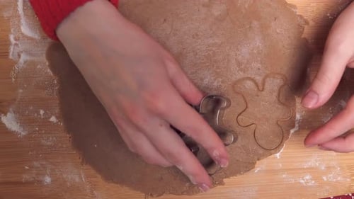 Cutting Gingerbread Man Cookie Shapes for Christmas Baking