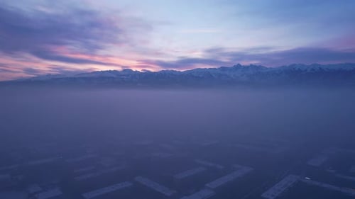 Dawn Over the City in Fog and Smog