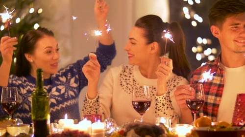 Friends celebrate the holidays with sparklers and wine