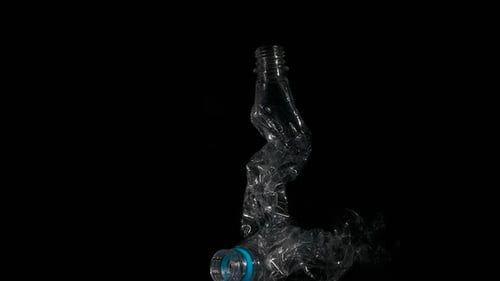 Crushed Plastic Bottle on a Black Background