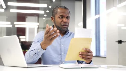 Man Receives Bad News in Office, Reads Letter