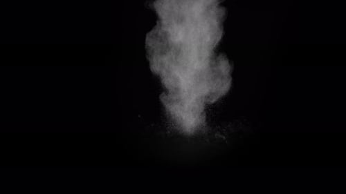 Sahara Collection: Sand sprinkling from the top and scattering slowly at the center over a black bac