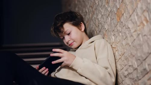 Focused Child Using a Tablet at Home