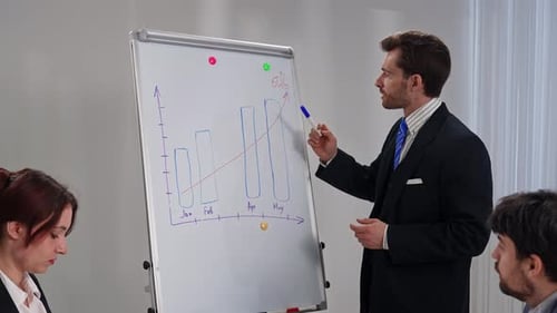 Executive Presenting Business Growth at Meeting