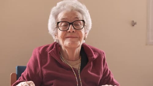 Elderly Woman with Short Gray Hair Talking in Nursing Home