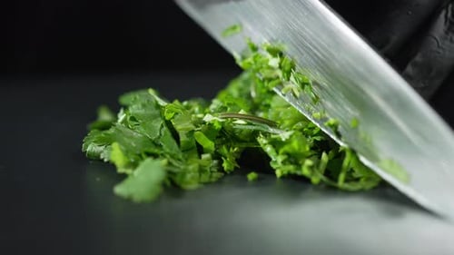 Chopping Parsley with Black Gloves and Silver Knife