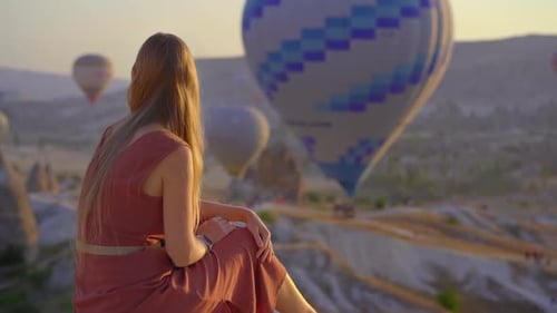 Tourist Woman Looking at Hot Air Balloons in Cappadocia Turkey Happy Travel in Turkey Concept Woman