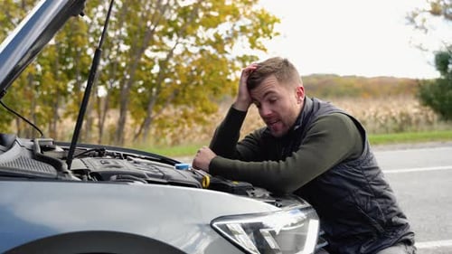 Frustrated Young Adult with Broken Down Car