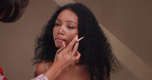 Model Having Makeup Applied With Brush