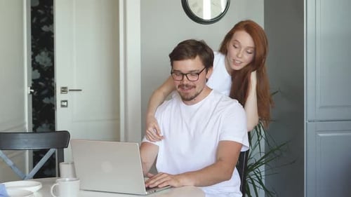Couple Using Laptop Computer Together at Home