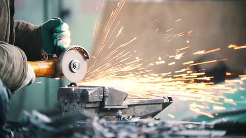 Industrial Concept A Man Worker Cut a Black Chain with