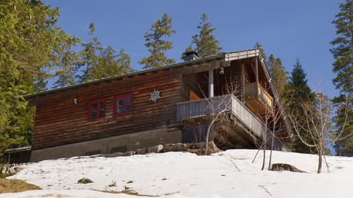 A View Of A Cozy Log Cabin In The Bavarian Alps In Germany.