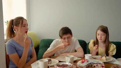 Family Enjoying Cake Together at Home Indoors