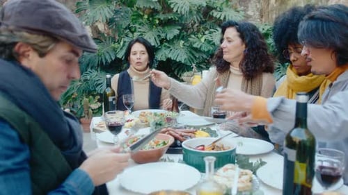 Friends Gather for Lunch Outside in Sunny Garden