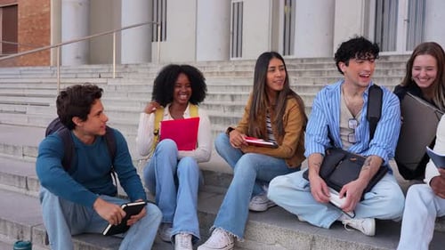 Diverse Group of University Students Laughing on Campus Steps
