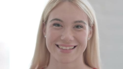 Close Up of Young Blonde Woman Smiling at Camera