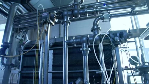 Silver stainless pipelines at a dairy factory. Tubes and pipes of different diameter