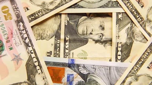A Bunch of US Dollar Banknotes of Money are Spinning in Closeup