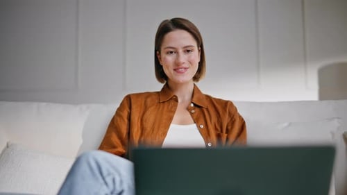 Young Adult Woman On Laptop In Her Home