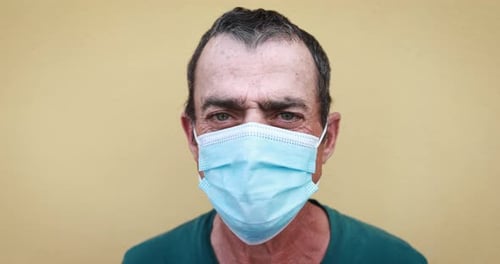 Man wearing a blue surgical face mask