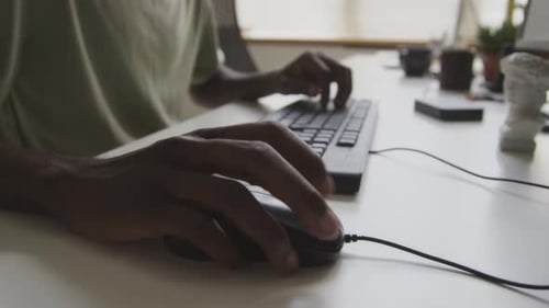 Hands Typing on Keyboard and Using Mouse