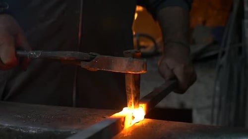 Blacksmith Shaping Metal on Anvil with Hammer