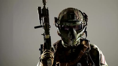 Soldier in Camouflage Holding a Rifle