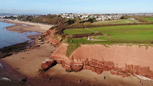 Aerial panning right shot of Jurassic Cliffs at Orcombe Point Exmouth Devon England