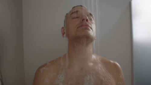 Man Washing Hair with Shampoo in Shower