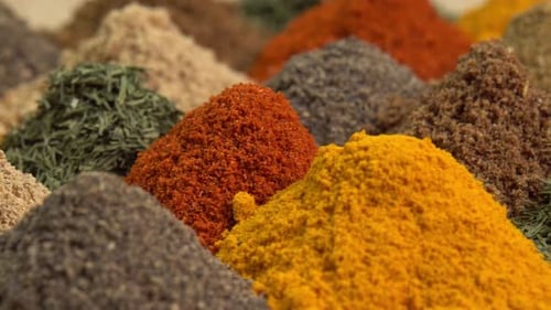 Spice and seasoning. Various fragrant spice market. Heap different Asian Spices rotated on wooden