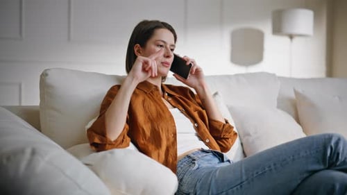 Woman Relaxing on Couch Talking on Phone