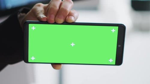 Hand Holding Mobile Phone with Green Screen