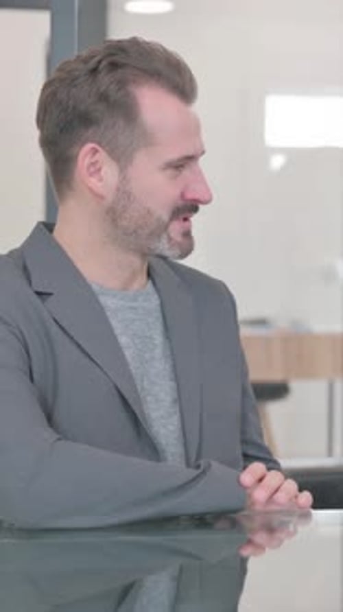 Young Colleagues Discussing Work in Office, vertical video