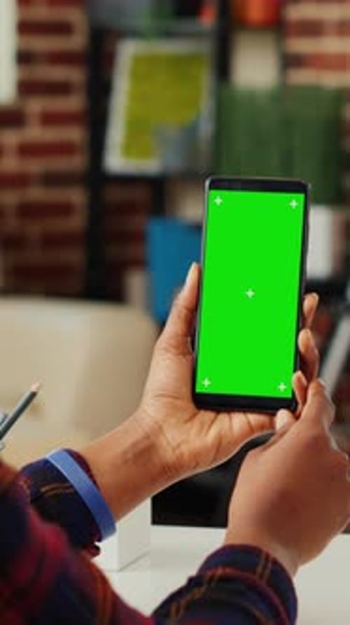 Smartphone with Green Screen Held in Hands