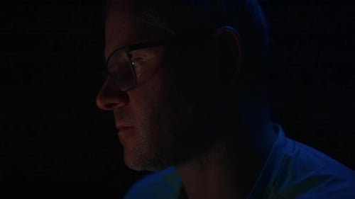 Man Engaged With Phone In Dim Lighting Conditions