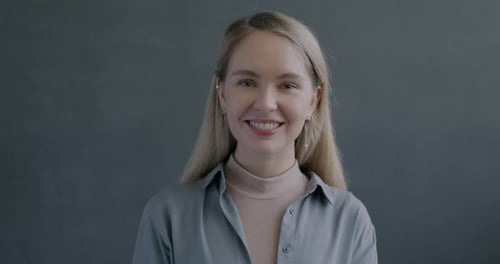 Smiling Woman Makes Okay Sign in Studio