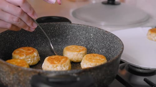 Frying Delicious Cheesecakes in a Pan at Home