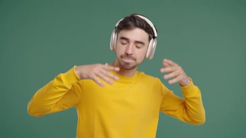 Active Young Man Dancing With Headphones On Green Happy Guy Great Mood