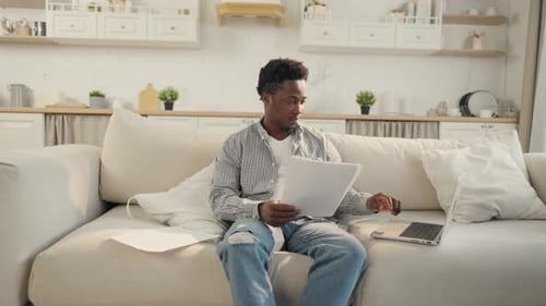 Young Adult Working at Home with Laptop