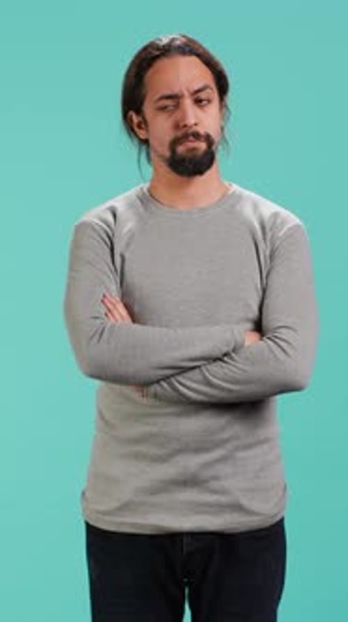 Vertical Video Grumpy Man Crossing Arms Feeling Upset By Events