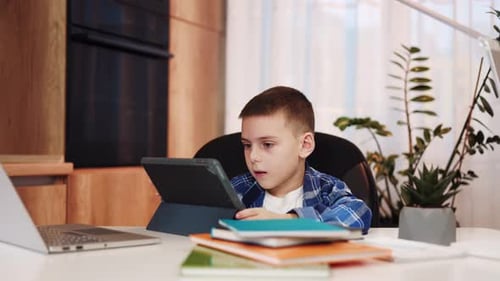 Little Guy Engaging in Remote Schooling Using Digital Tablet at Cozy Home
